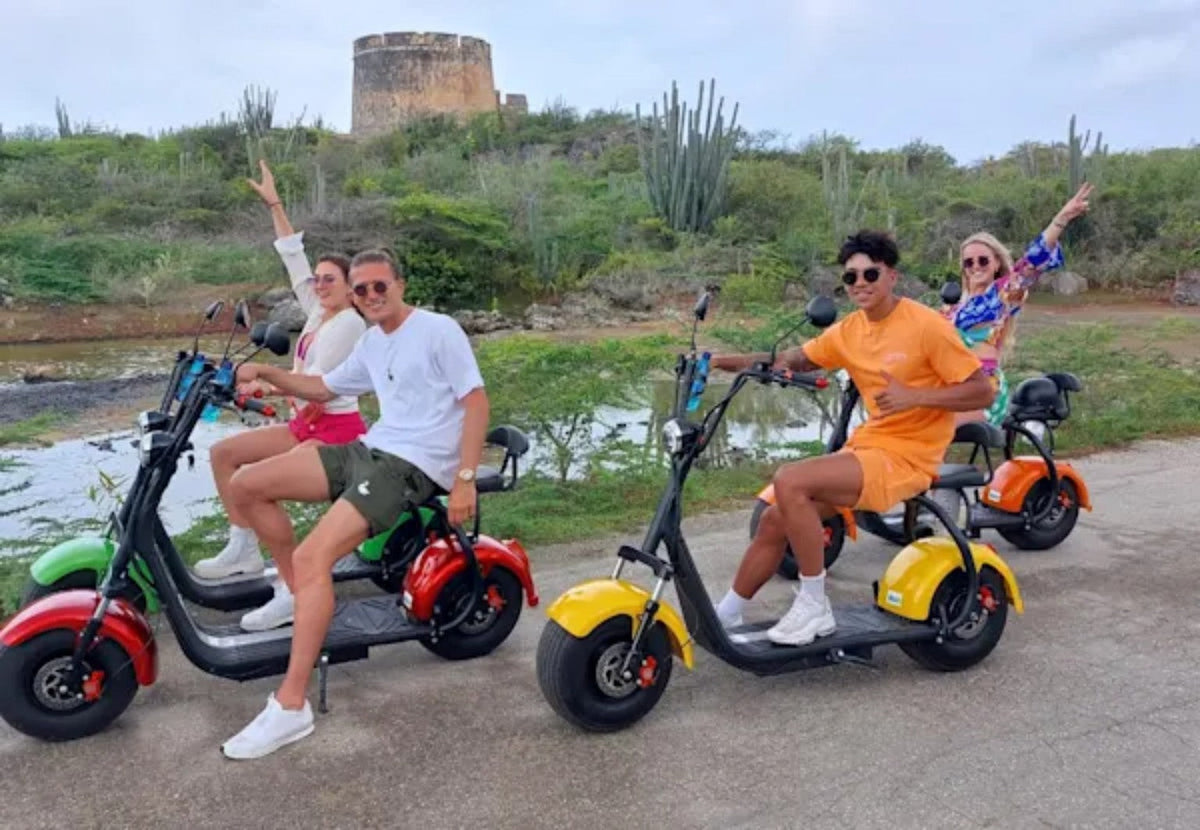 Guests on a colorful Iguana Ride e-scooter tour in Curaçao