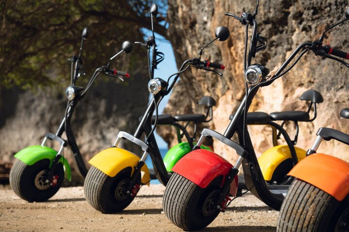 Colorful electric scooters from Iguana Ride Curaçao ready for rental