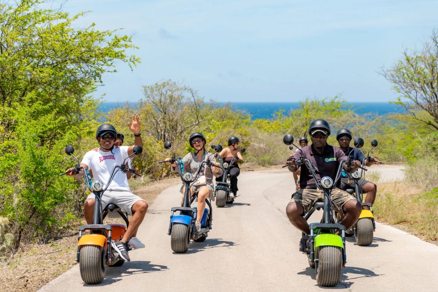 Group riding electric scooters in Curaçao with Iguana Ride