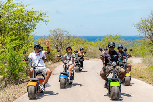 Group riding electric scooters in Curaçao with Iguana Ride